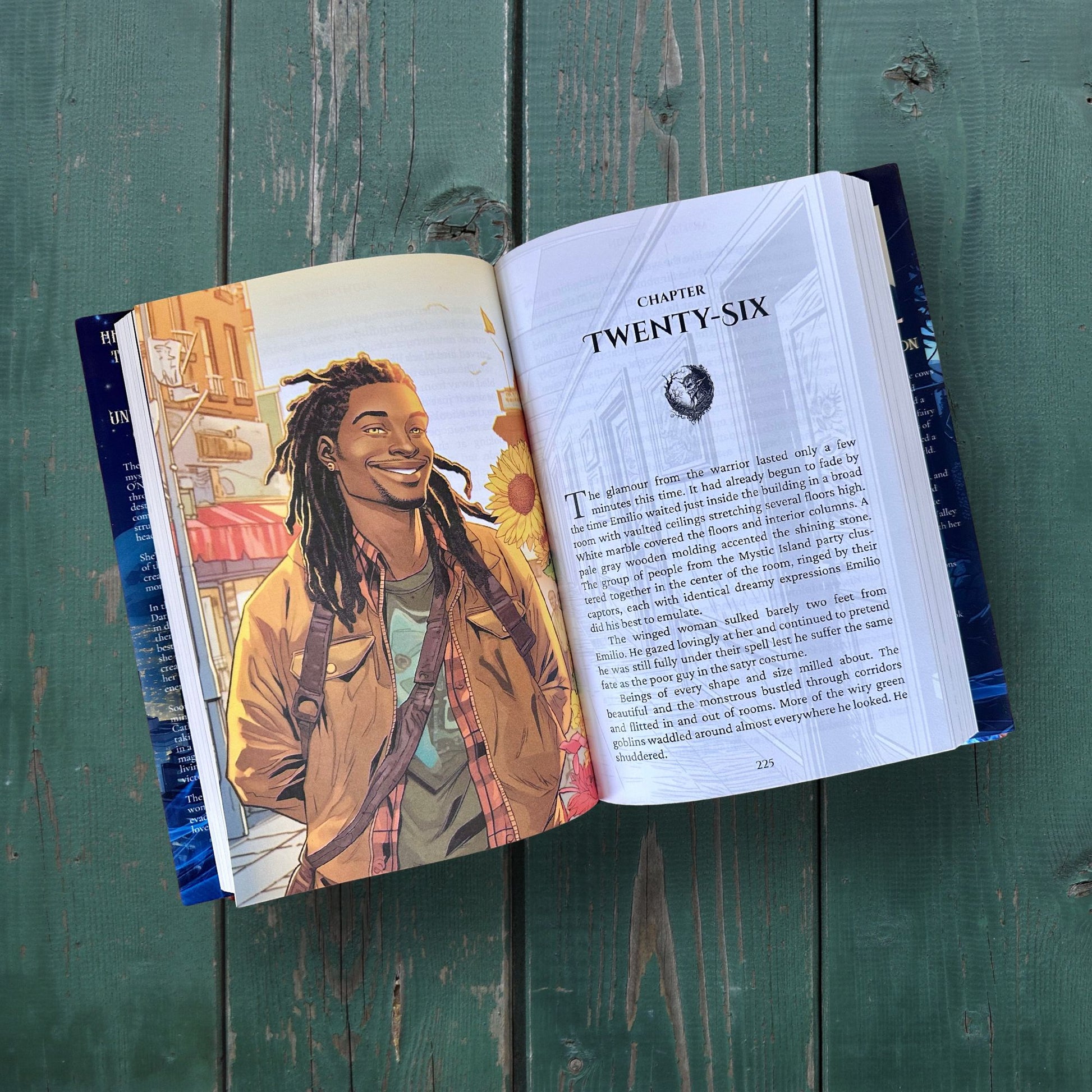 Open book with a colorful illustration of a person on a wooden surface
